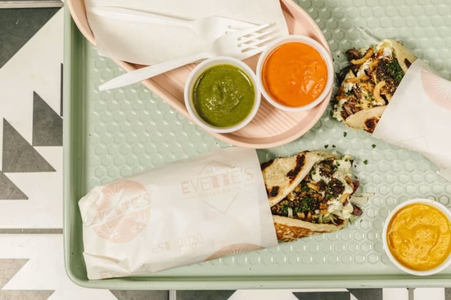 Evette's takeout bag and tacos on a patterned tray