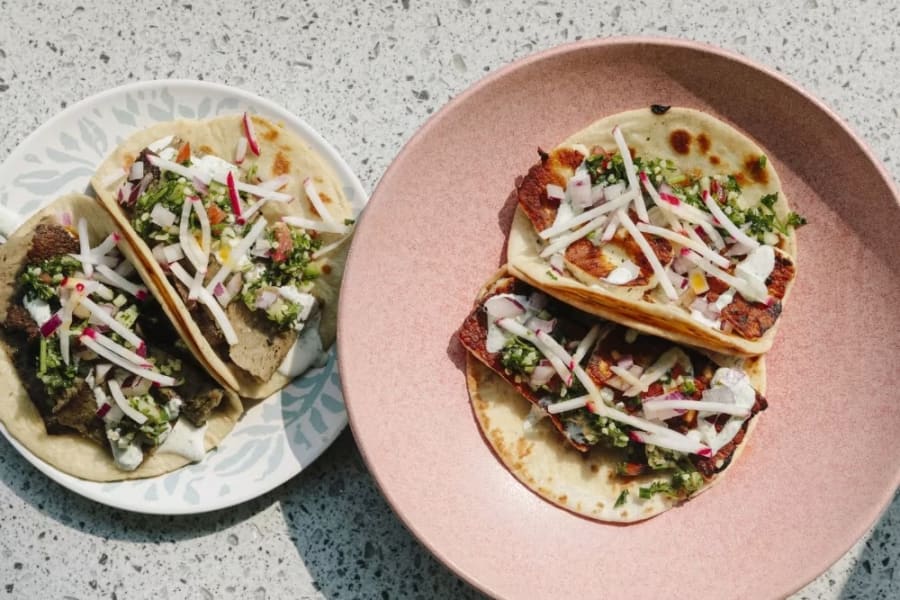Shawarma tacos on a blush pink plate