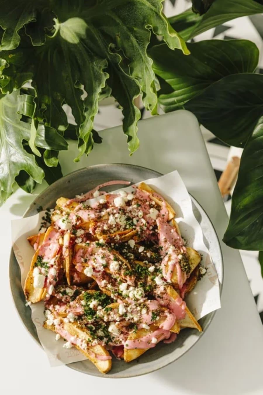 Loaded fries with pink tahini and feta