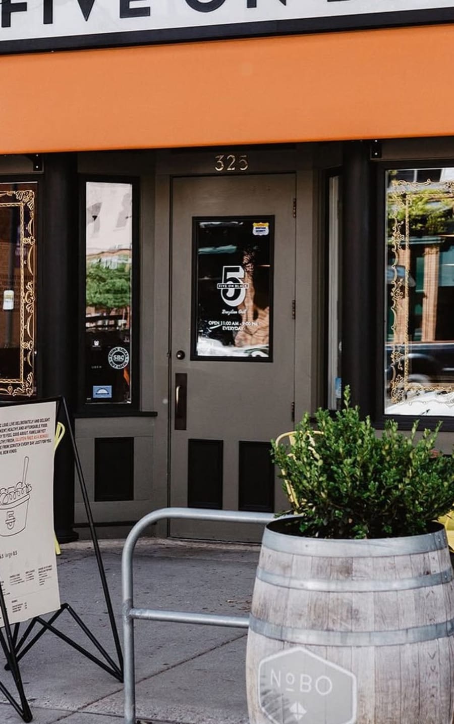 The orange awning and front door of Five on Black at 325 North Higgins in downtown Missoula