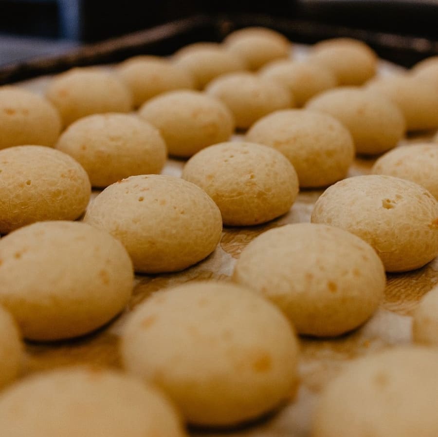 A fresh tray of house-made Pão de Queijo cheese bread