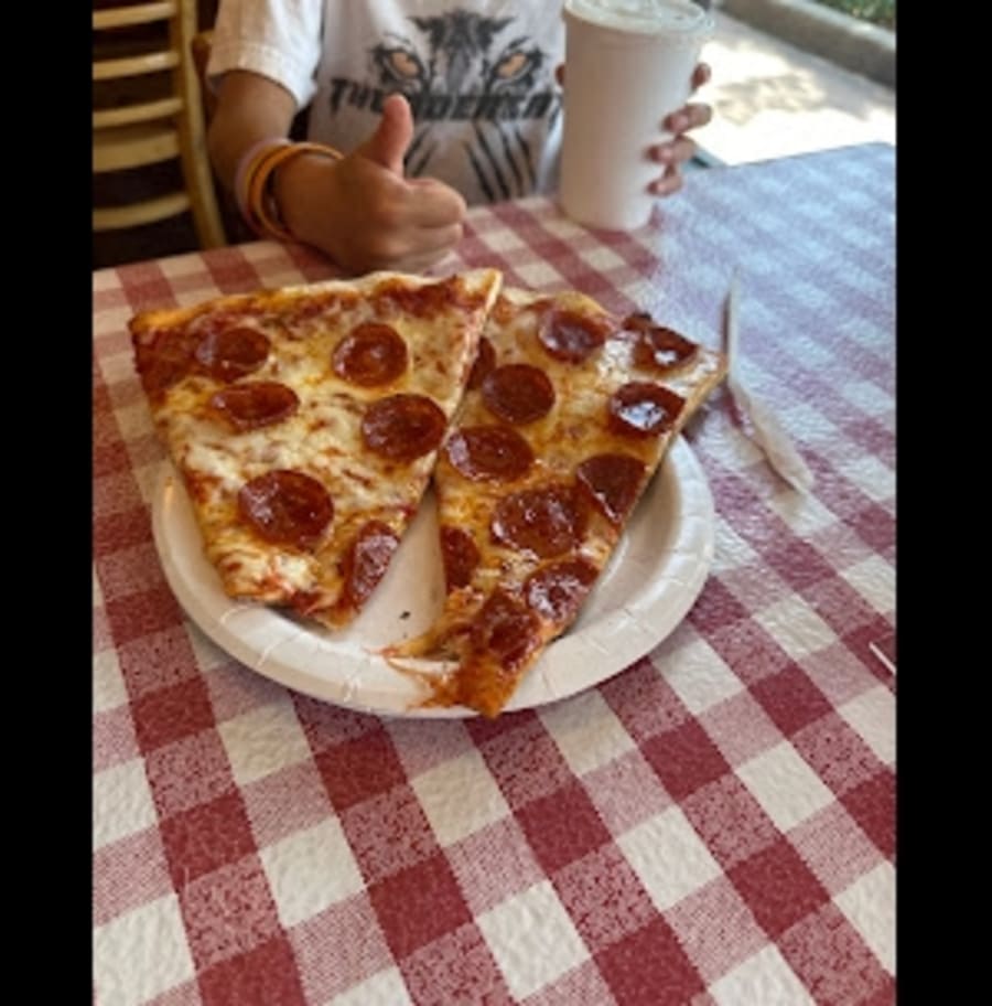 New York-style pepperoni slices on a checkered table