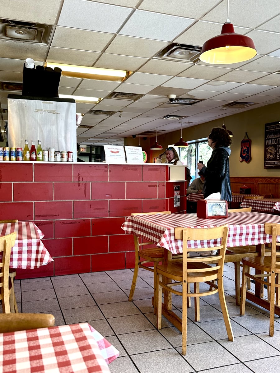 The red-brick dining room with checkered tablecloths