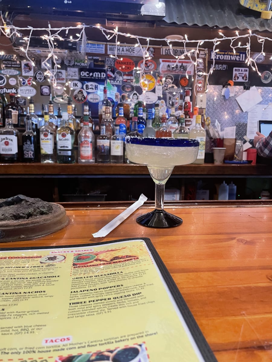 A margarita on the wooden bar at Mother's Cantina