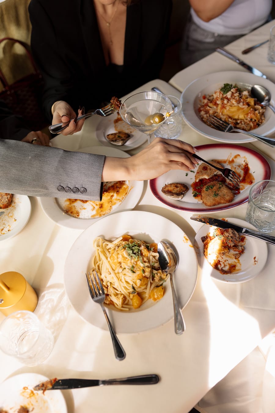 Pasta served tableside on white linen