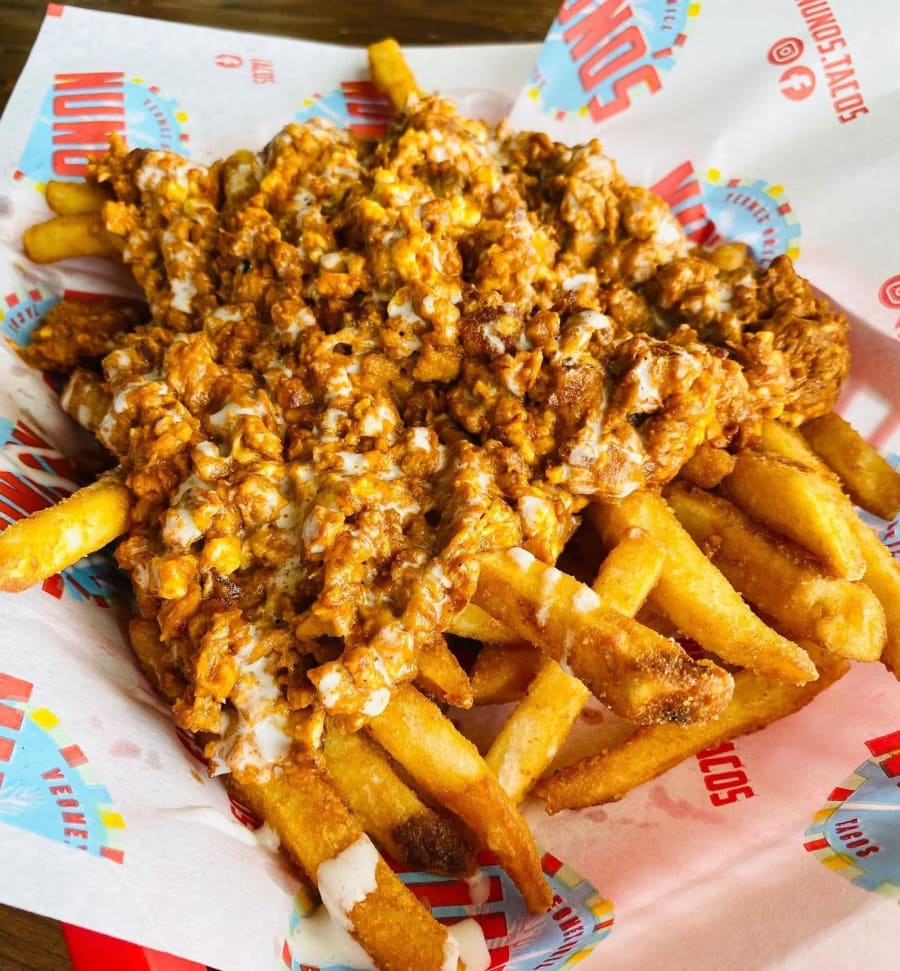 Loaded vegan fries with chorizo on Nuno's branded paper