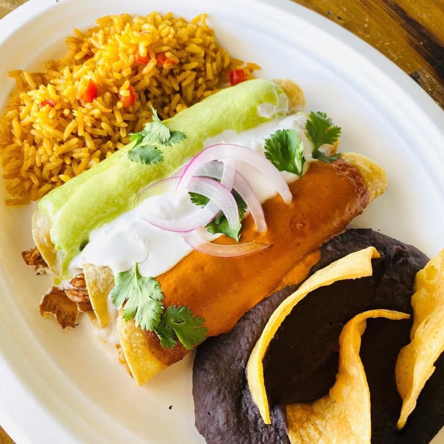 Enchiladas and flautas with rice and refried beans