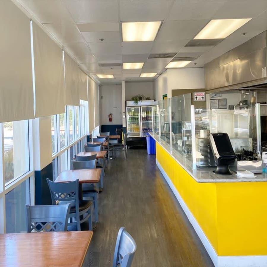 The dining room and yellow counter inside the shop