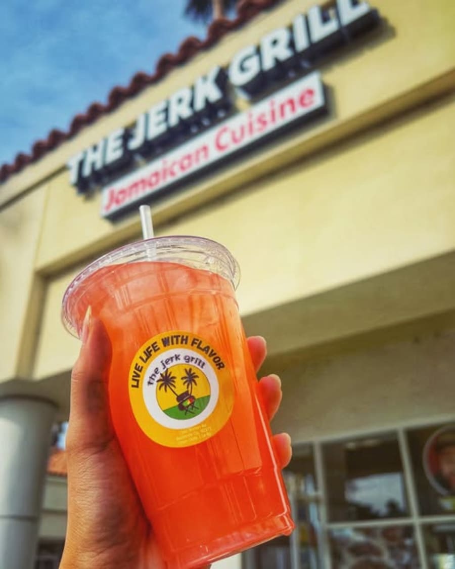 A cold drink held up outside the Barton Road storefront