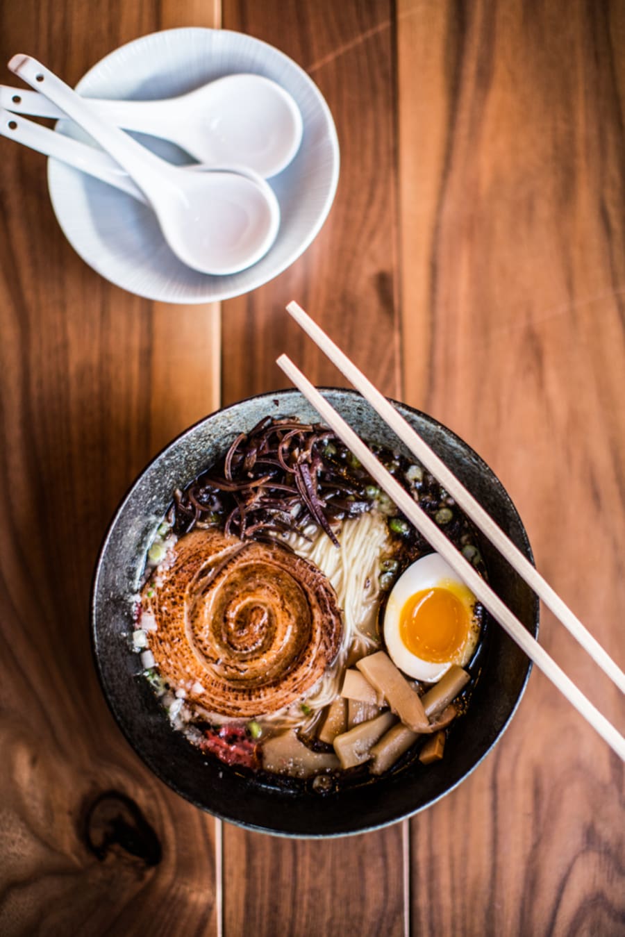 A bowl of ramen with chopsticks
