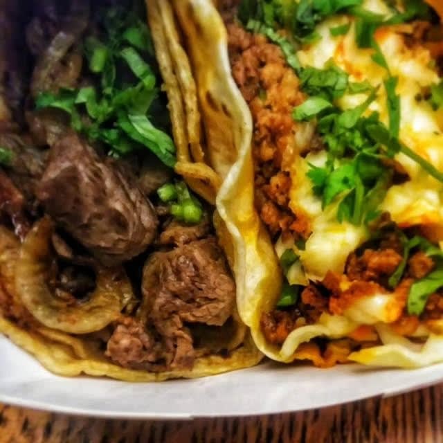 A trio of Carbón tacos with cilantro and salsa