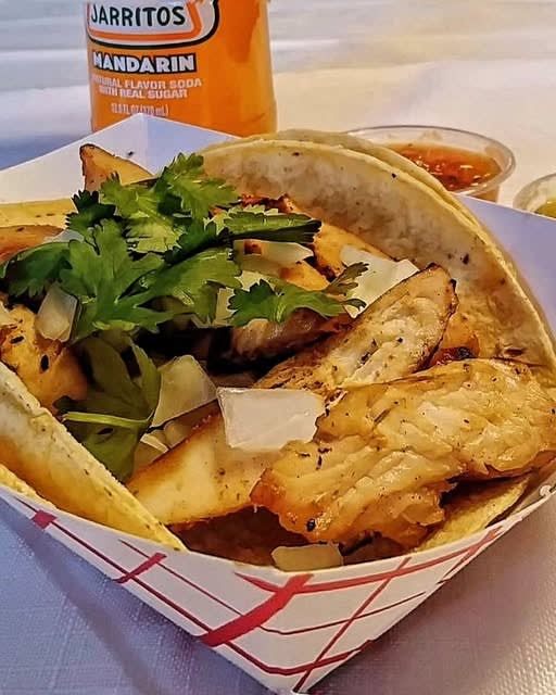 Grilled fish taco basket with fries and a Jarritos