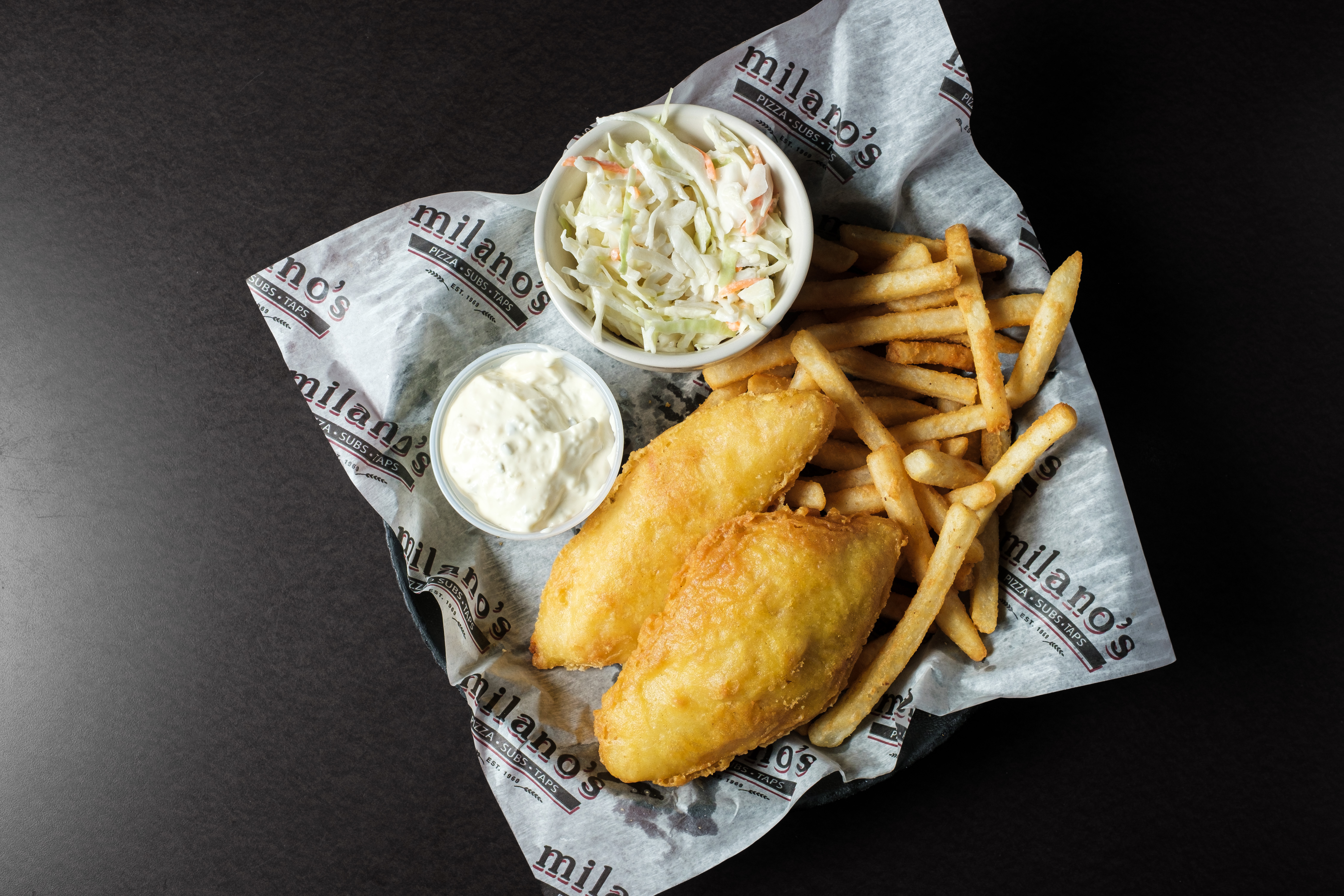 Fried fish and chips basket with coleslaw and tartar sauce