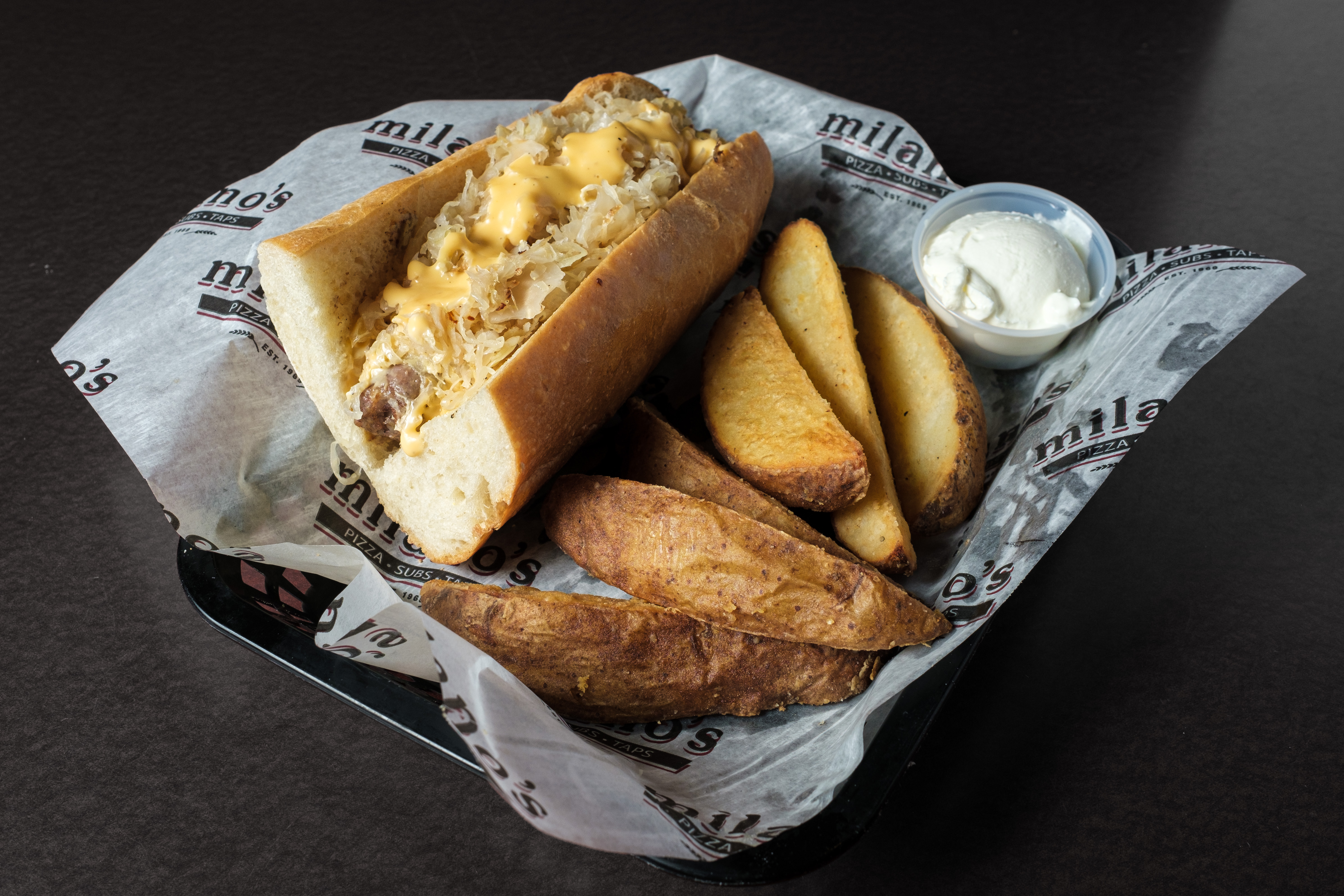 Atlantic City style sub with chips and a cold drink on the bar