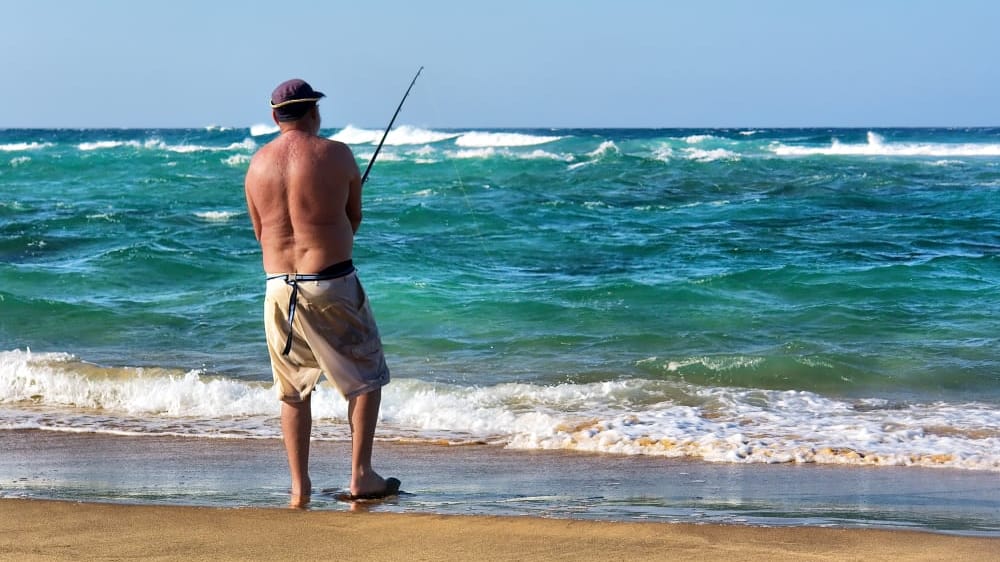 Old angler on sunset beach. shot in sodwana bay nature reserve sfhx1b