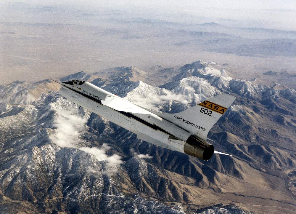 a 1972 photo of an F-8 Digital Fly-By-Wire (DFBW) aircraft in flight, by the mounstains