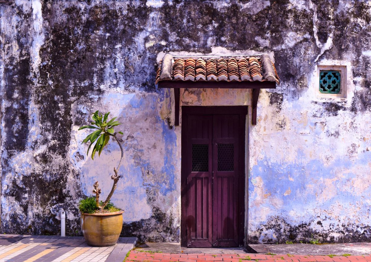 vibrant royal purple door / entrance to a cottage with a faded purple wall
