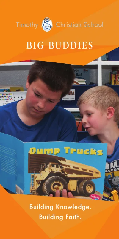 Building Community Banner:  A student in an older grade is reading a book to a student in a younger grade.