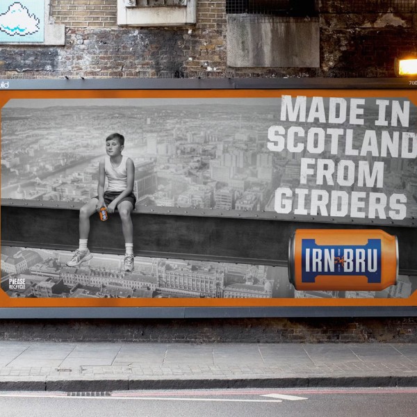 A street billboard features a boy sitting on a girder with an IRN-BRU can, promoting the drink.