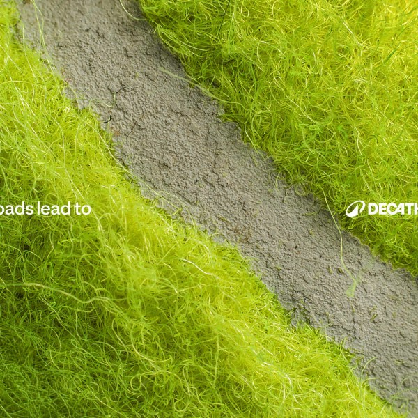 A green textured background with the text "All roads lead to Decathlon".