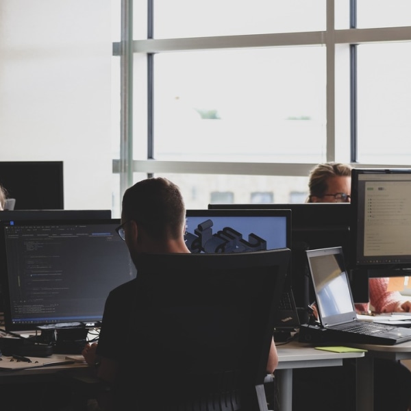 Developers in an office looking at computer screens