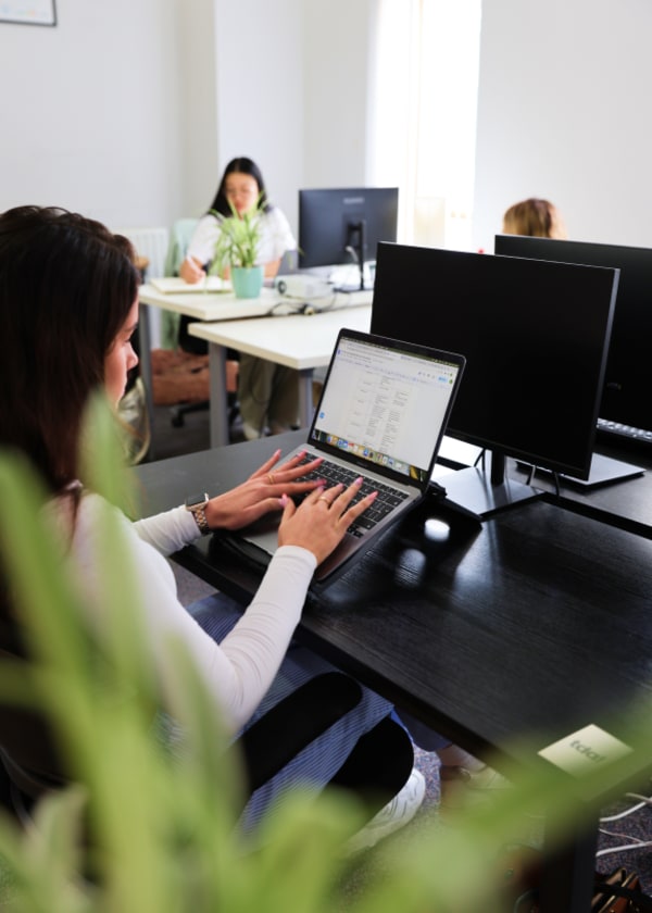 Woman working on laptop at desk