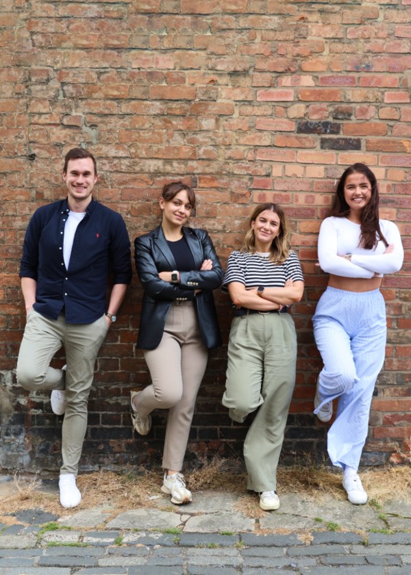 A cheerful group of friends smiling and posing together for a memorable photo.