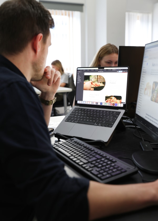 Man working on laptop at desk.