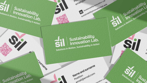 Scattered green business cards with 'Sustainability Innovation Lab' branding and QR codes.