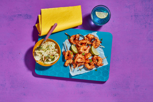 A plate with prawns and coleslaw, a delicious seafood dish with a refreshing side of coleslaw.