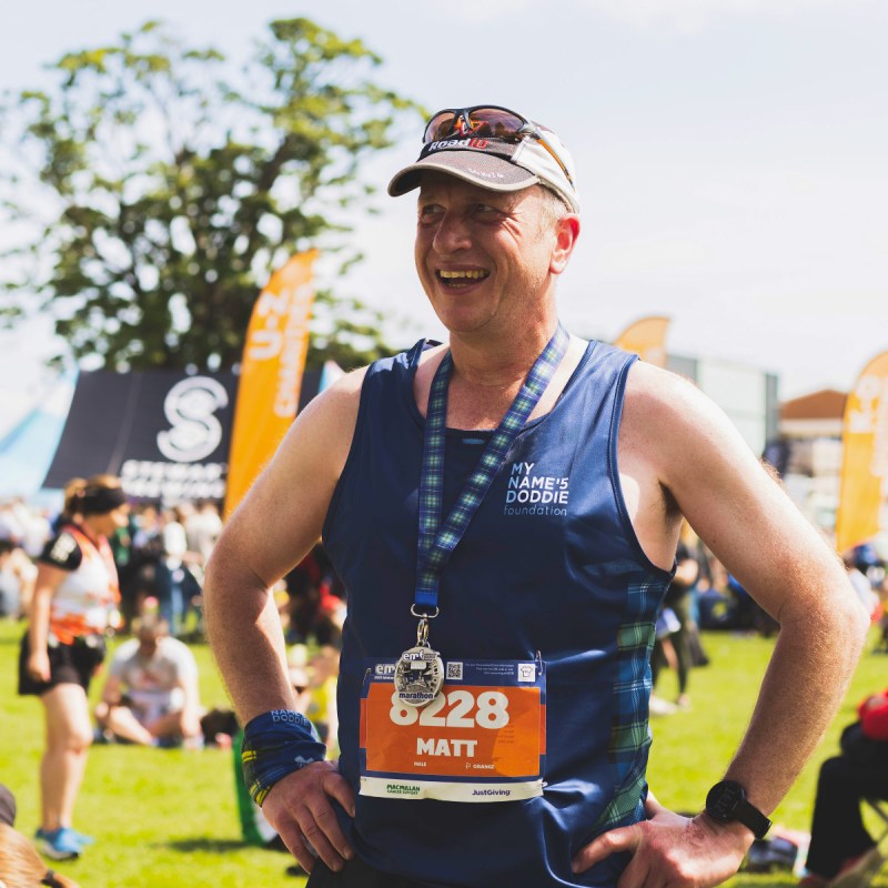 A smiling supporter wearing branded running gear