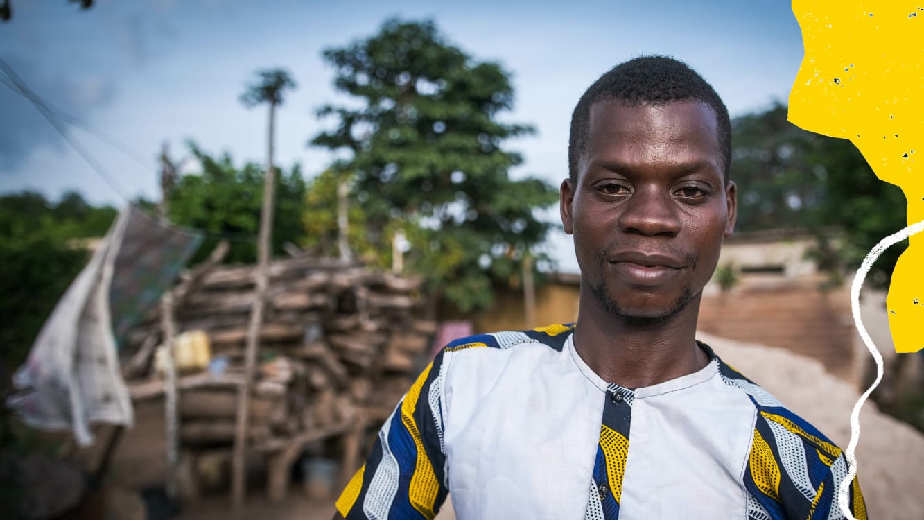 A man standing with trees in the background