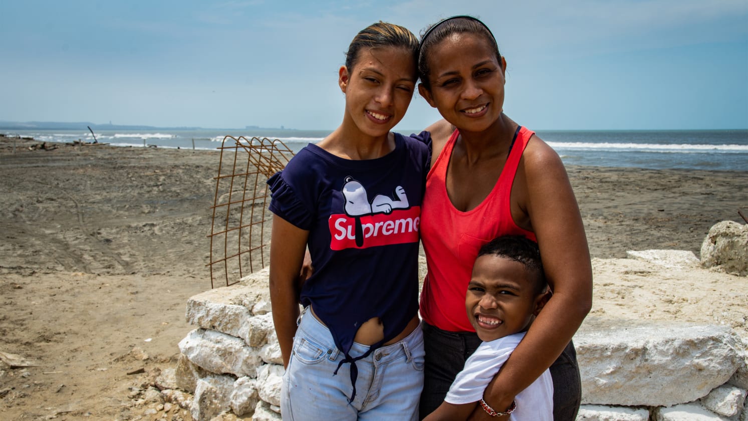 Woman and her two children on a beach