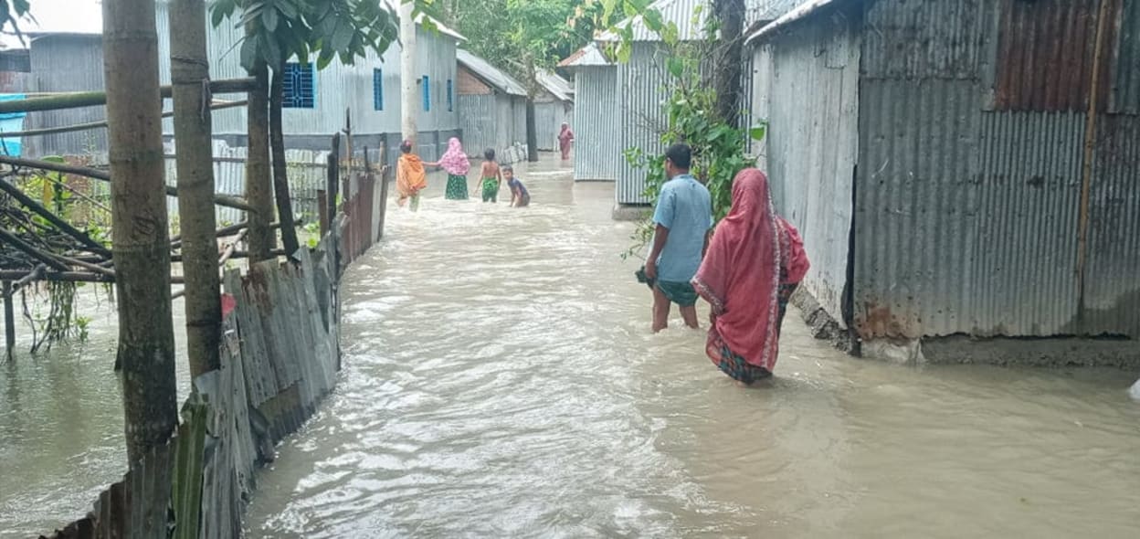 People walk through flooded streets