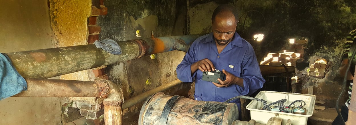 Deograce, a Tearfund technician, repairing the pump at Kasango. Photo: Nathanael Hollands/Tearfund