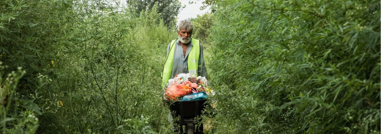 Man with barrow of rubbish
