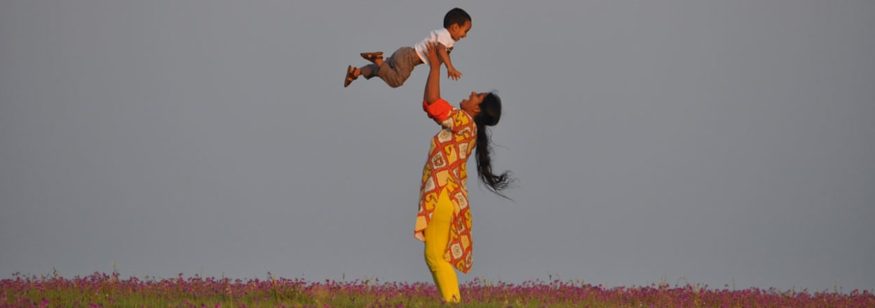 Mother lifting child up in the air