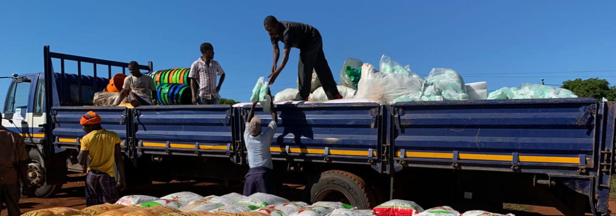 Workers loading sacks of aid onto truck