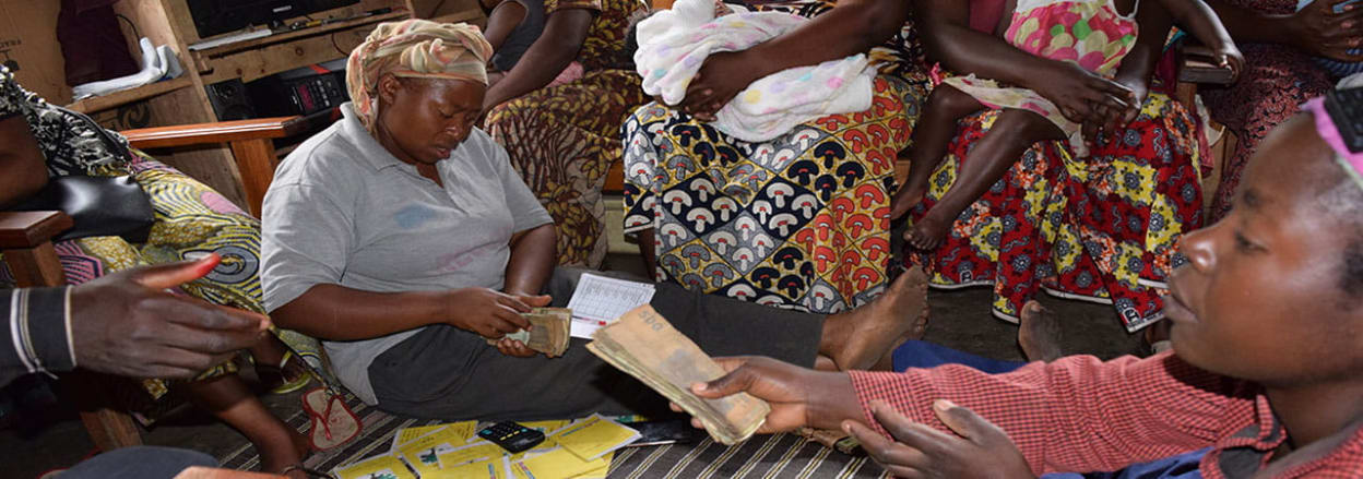 Women handing over money in self-help group