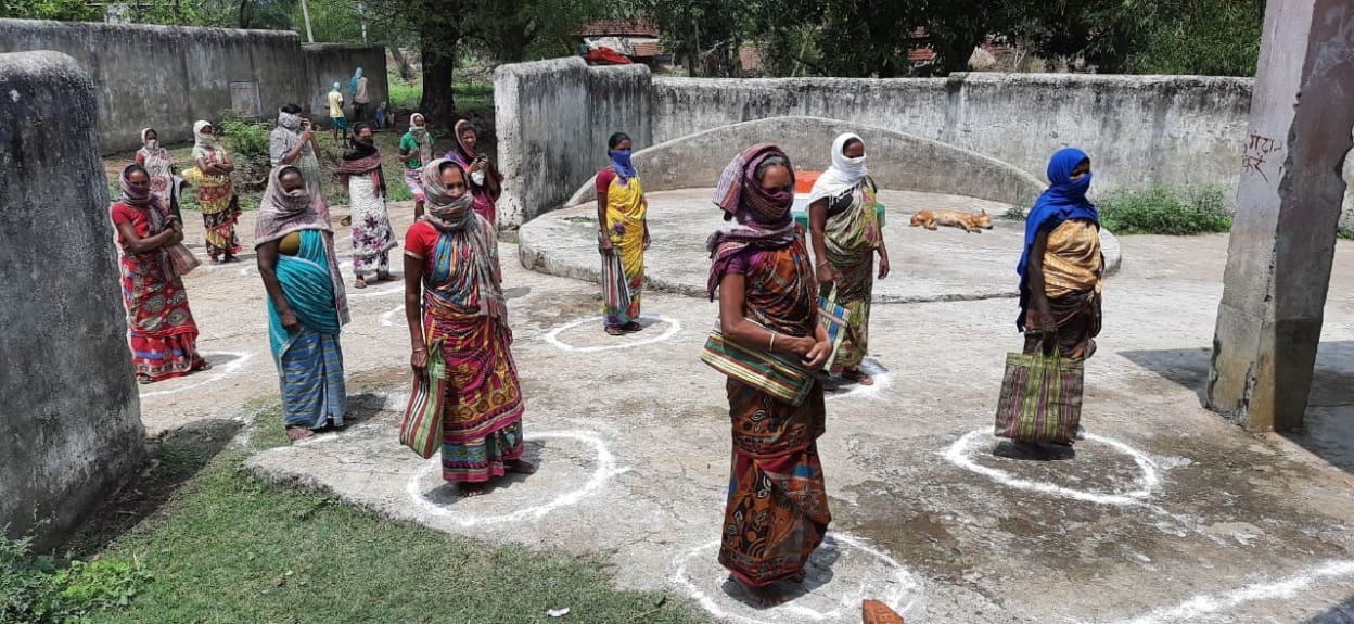 People queue social distanced in India