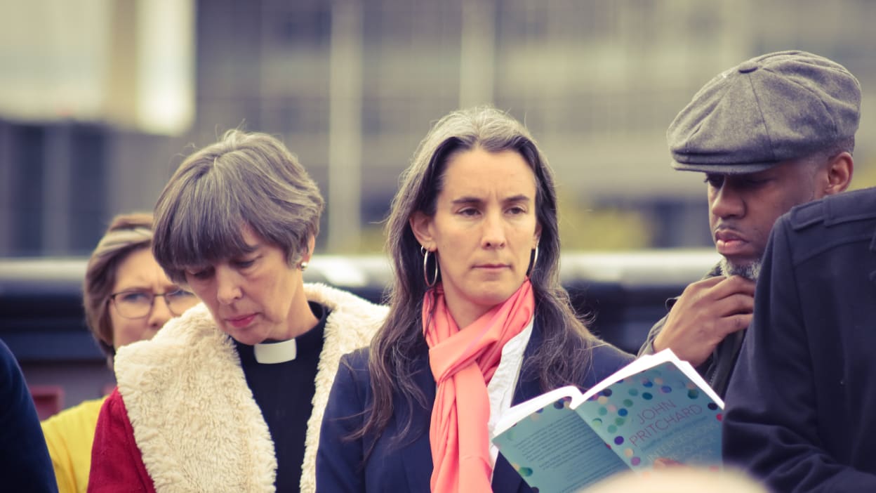 Ruth Valerio leading a prayer on Faith Bridge as part of a demonstration against climate change.