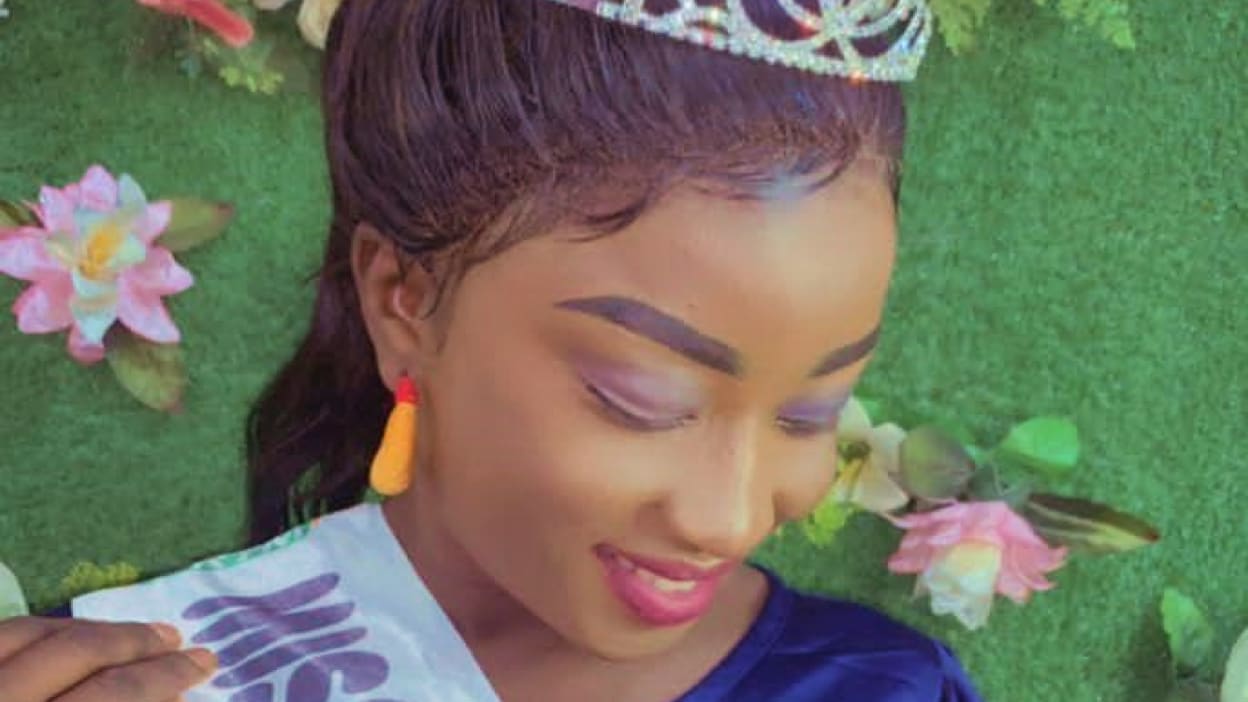 A young woman (Mounina) wears a sparkly crown and a beauty queen sash. She smiles brightly as she looks down. Mounina is using her platform as 1st princess Miss Mali to raise awareness about the consequences of child marriage.