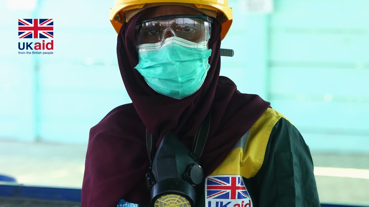 Kaneez wears protective equipment to keep her safe from disease while she works at the Haryali Hub.