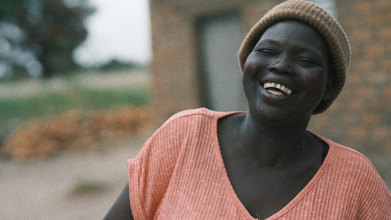 Mary smiles broadly as she talks about the excellent changes in her life with the help of Tearfund's Transforming Communities programme.