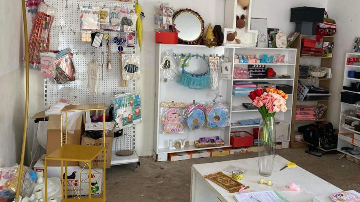 A small store with brightly-coloured paper and party items for sale.