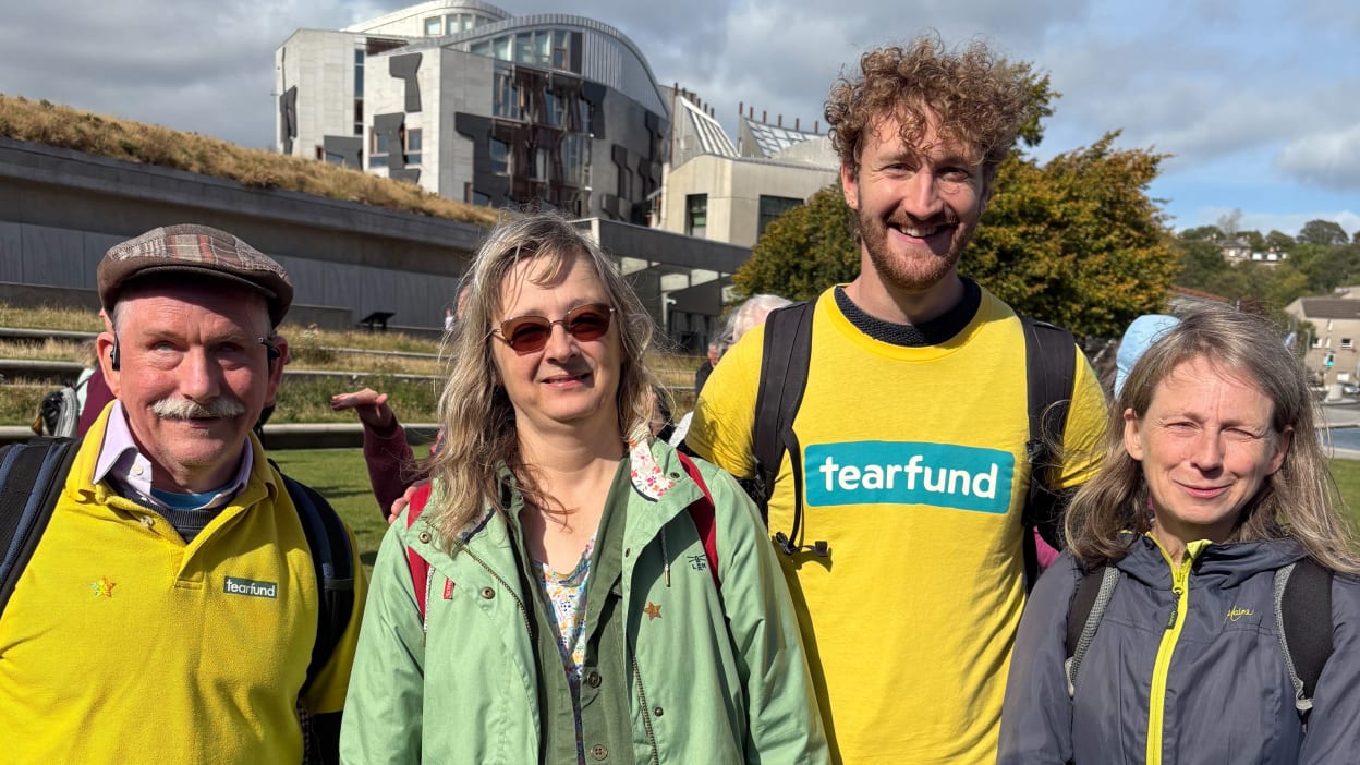 Group of people in Edinburgh with the Scottish Parliament in the background, supporting Tearfund.