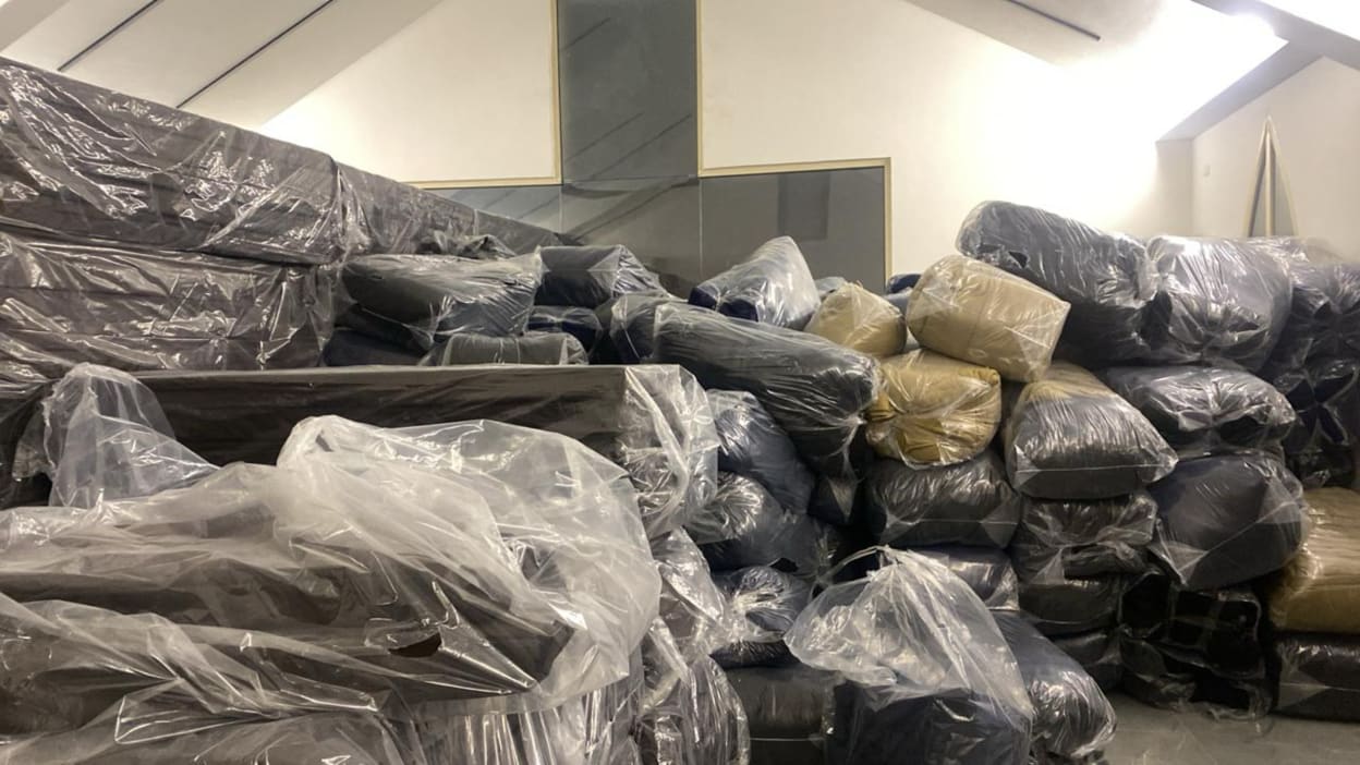 A pile of mattresses and blankets stored at a church hall