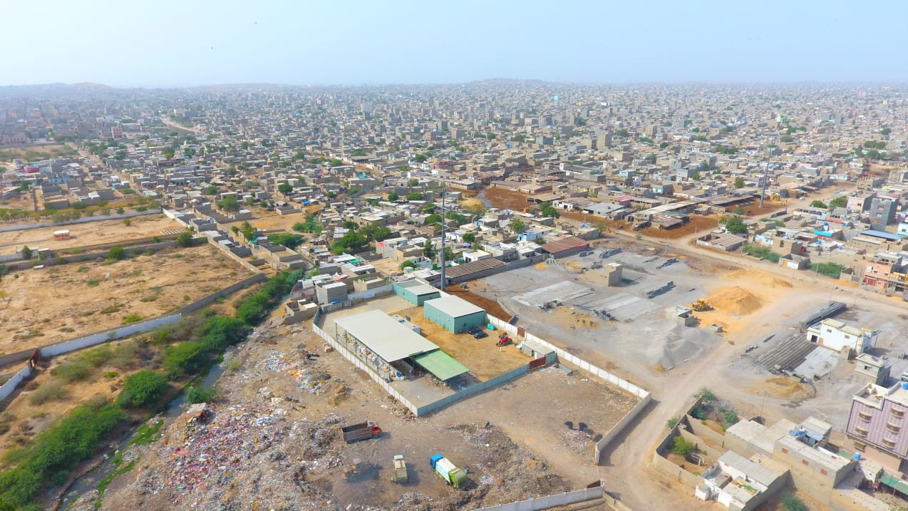 An aerial photograph looking down on a town which stretches to the horizon