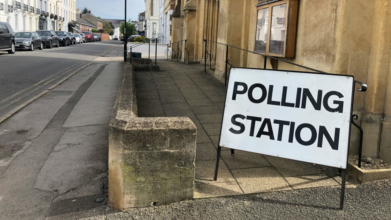 A sign that reads polling station outside of a community centre in the UK. Image: Red Dot/Unsplash.