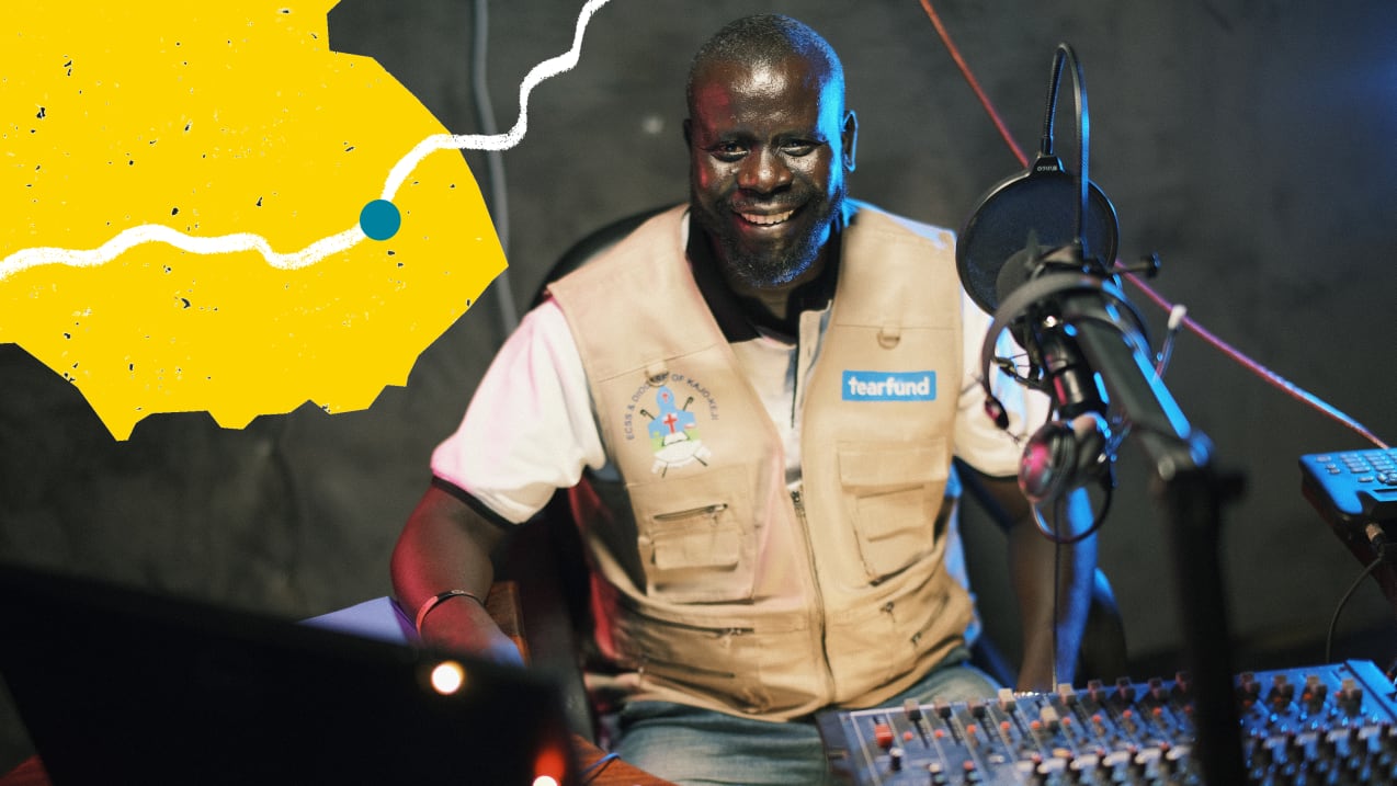 Smiling man in vest with audio mixing board, microphone and a yellow graphic overlay.